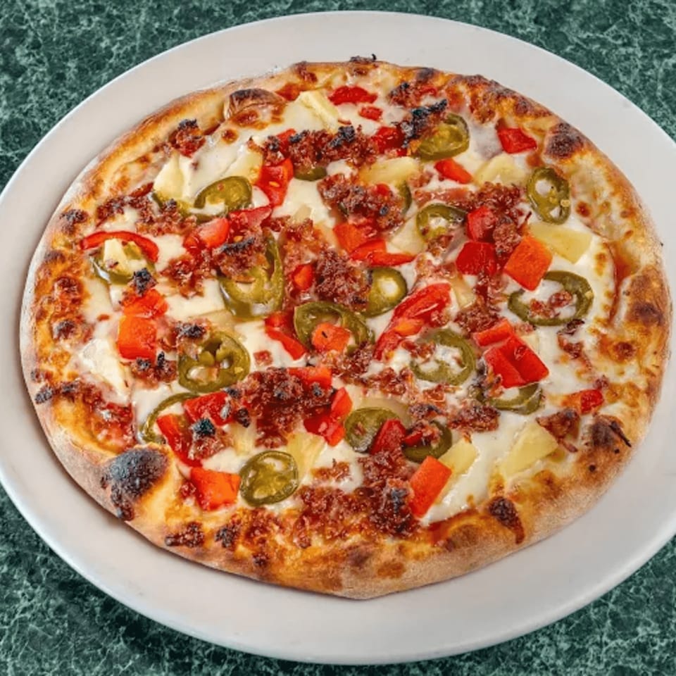 North Beach Pizza's pizza with cheese, red peppers, jalapeños, pineapple, and crumbled sausage.